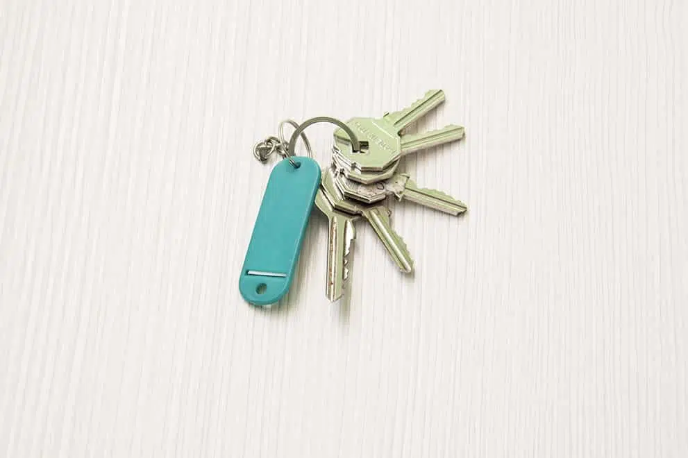 An image of a set of keys on a white wooden table to represent "Real Estate Closing Services in Waynesville NC" symbolically